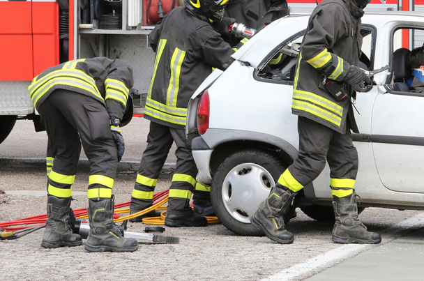 γενναίοι πυροσβέστες να ανακουφίσει μια τραυματισμένη μετά από τροχαίο ατύχημα  - Φωτογραφία, εικόνα