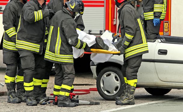 wounded person carried by firefighters on a stretcher - Photo, Image