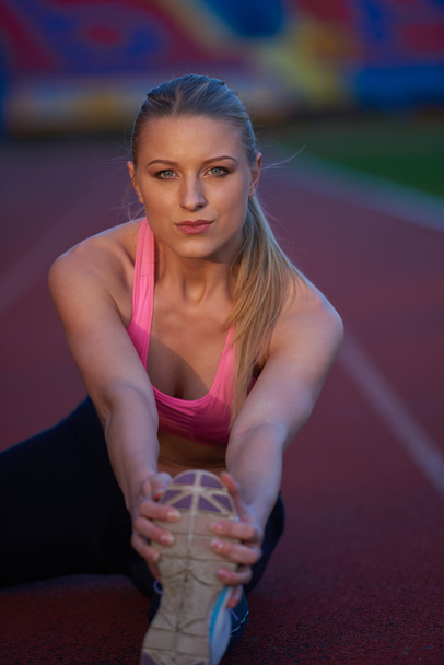 sporty woman on athletic race track - Photo, Image