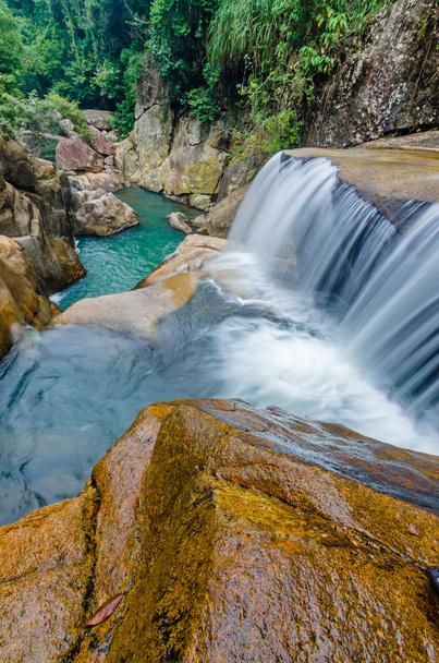 Jungle waterfall with flowing water, large rocks - Foto, imagen