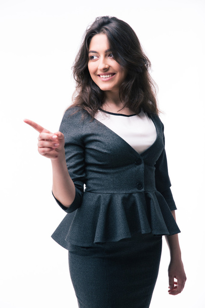 Smiling businesswoman pointing finger away - Photo, Image