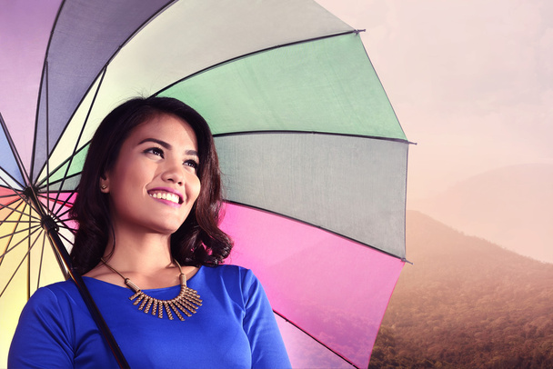 Asian woman holding umbrella smiling - Foto, Imagen