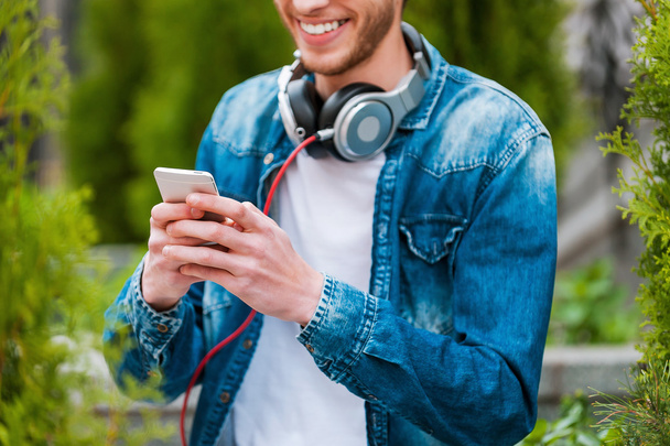 young man holding mobile phone - Photo, Image