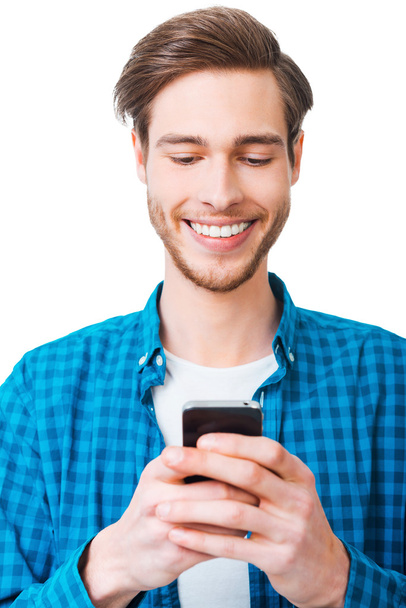 young man in shirt holding mobile phone - Foto, afbeelding