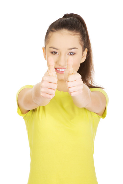 Happy woman with thumbs up. - 写真・画像