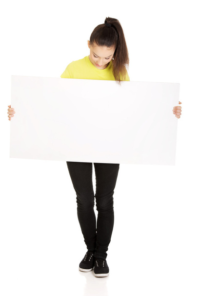 Young happy woman with blank board. - 写真・画像