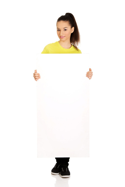 Young happy woman with blank board. - Foto, imagen