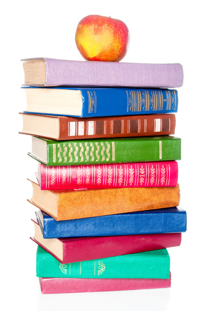 Stack of old books and an apple on white background - Foto, Imagem