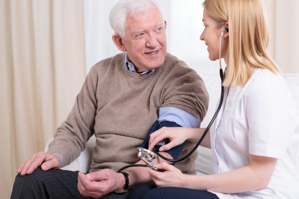 Caregiver checking the hypertension - Fotoğraf, Görsel
