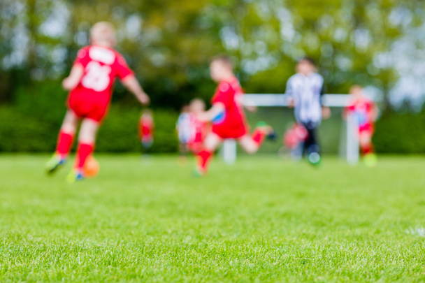 Blurred kids playing youth football match - Foto, immagini