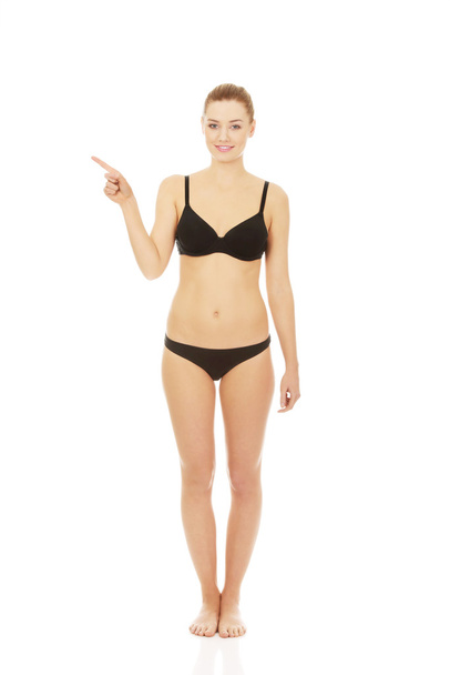 Happy woman in bikini pointing up. - Photo, Image