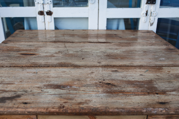 дерев'яний стіл проти старих дверей
 - Фото, зображення
