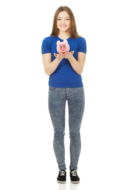 Teenage woman holding piggybank. - Foto, Imagem