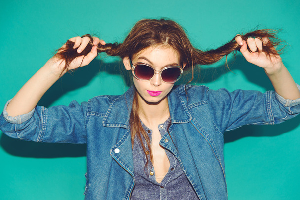 Emotional pretty young hipster girl make funny face on blue background - Фото, изображение