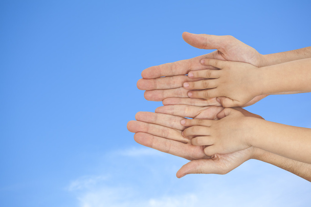 Father and son holding hands on a sky background - Photo, Image