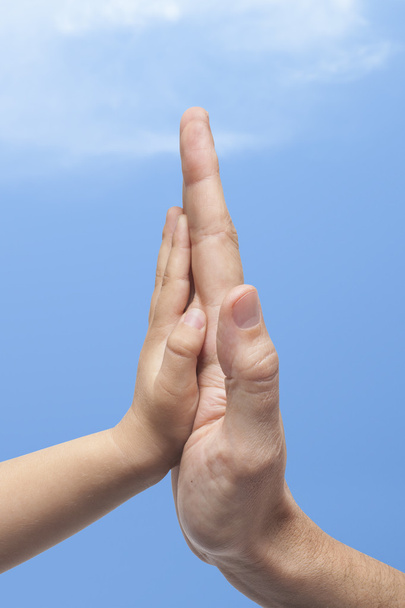 Father and son in high five gesture on sky background. - Photo, Image