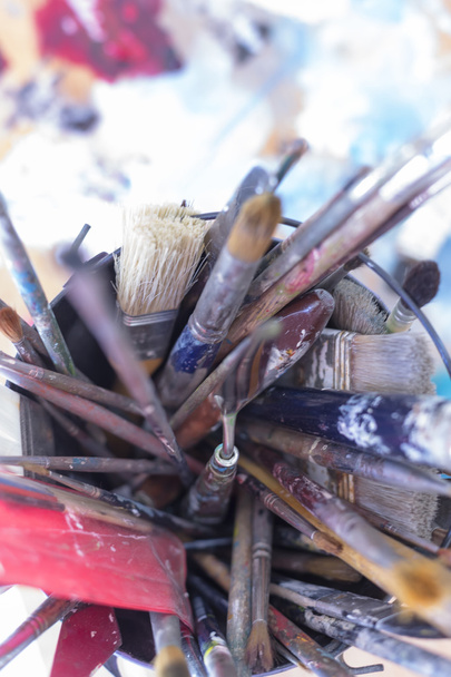 Paintbrushes on a container - painting session - Photo, Image