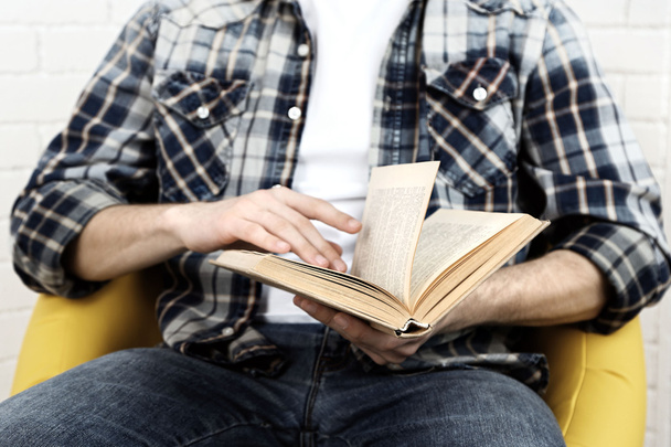 Young man reading book - Fotografie, Obrázek