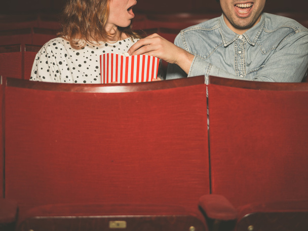 Couple watching a film in a movie theater - Fotó, kép