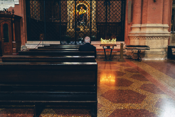 Elderly man worshipping at an altar - Photo, Image