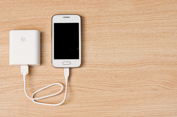 smartphone with a power bank charger - 写真・画像
