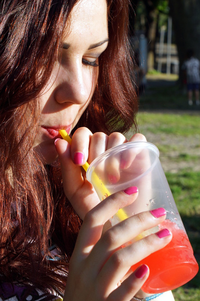 Young lady eating slush in the park - Φωτογραφία, εικόνα