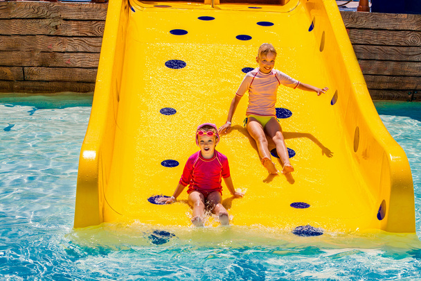 Children on water slide at aquapark. - Photo, Image