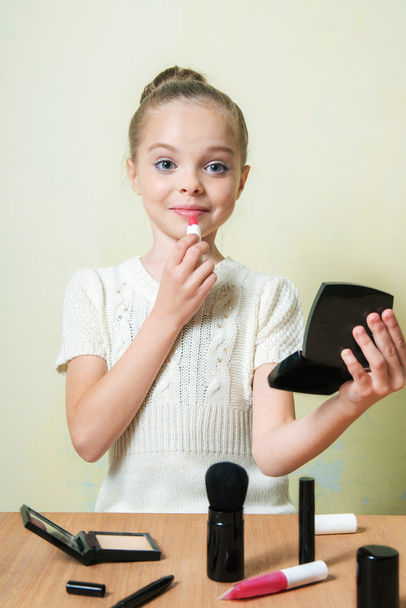 Fashion little girl applying make up - Fotó, kép