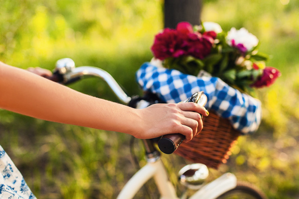 colorful flowers in bicycle basket - 写真・画像