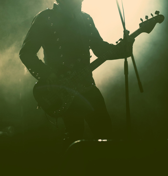 Guitarist silhouette in smoke during concert - retro style photo - Fotó, kép
