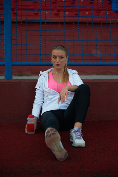 sporty woman on athletic race track - Foto, Imagen