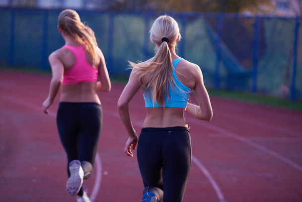 Athletic women on athletics race track - Foto, imagen