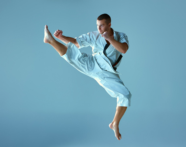 Man in white kimono training karate - Photo, image