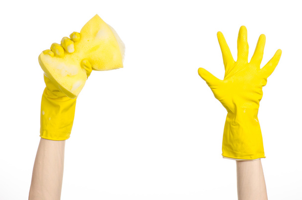 Cleaning the house and sanitation topic: Hand holding a yellow sponge wet with foam isolated on a white background in studio - Zdjęcie, obraz