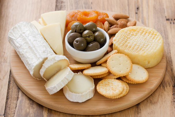 Cheese with olives, dry fruits and cookies - 写真・画像