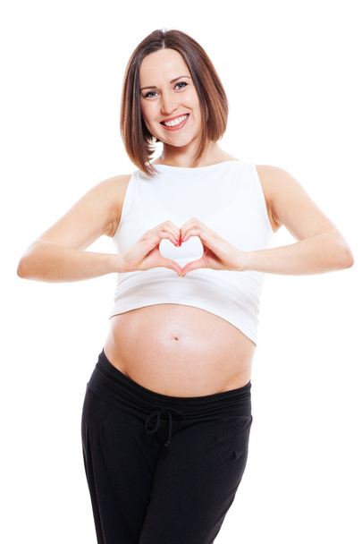 έγκυος γυναίκα δείχνει δάχτυλα όπως καρδιά - Φωτογραφία, εικόνα