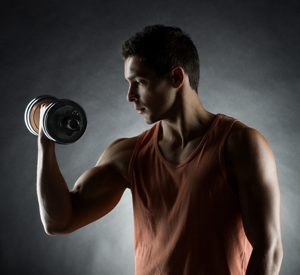 young man with dumbbell - Photo, Image