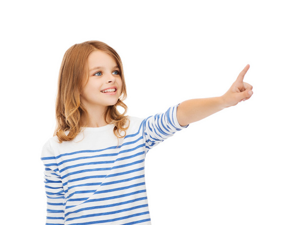 smiling girl pointing at virtual screen - Fotó, kép