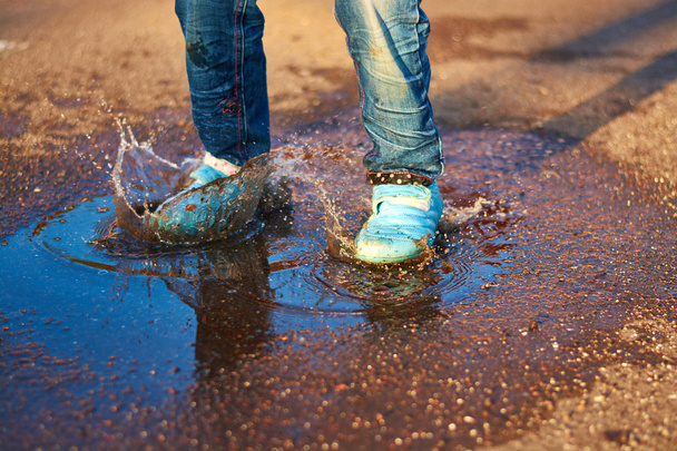 The child jumps in a puddle - Photo, Image