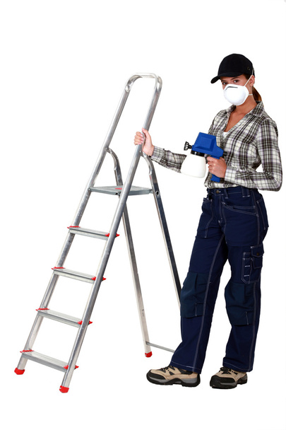 Woman stood by ladder holding spray paint - Φωτογραφία, εικόνα