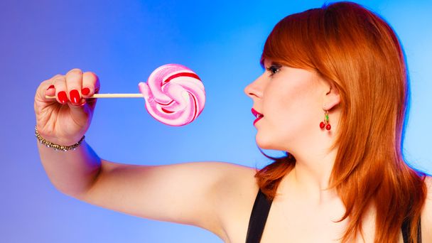 Woman with sweet candy lollipop in hand. - Zdjęcie, obraz