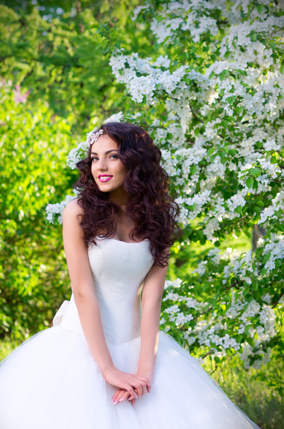 Bride on the background of blooming apple trees - 写真・画像