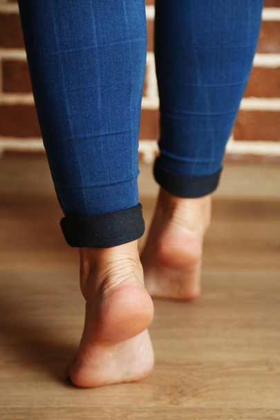 Beautiful female legs on wooden floor background - Valokuva, kuva