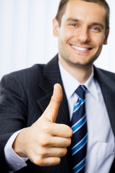 Happy businessman with thumbs up gesture - Фото, изображение