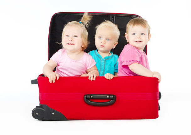Children sitting inside red suitcase - Foto, Imagem