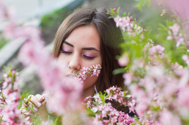 portrait of young beautiful girl in flowers - Zdjęcie, obraz