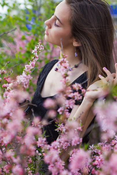 portrait of young beautiful girl in flowers - Фото, зображення