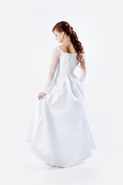 Portrait of happy bride in wedding dress, white background, space for text on the right - Фото, зображення