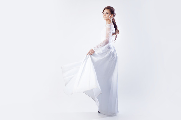 Beautiful bride in wedding dress, white background - Fotografie, Obrázek