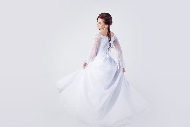 Beautiful bride in wedding dress, white background - Fotografie, Obrázek